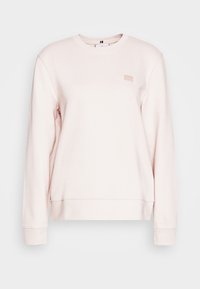 Felpa rosa chiaro con maniche lunghe, polsini e orlo a coste, con un piccolo logo del brand in rilievo sul petto. Materiale morbido in misto cotone.