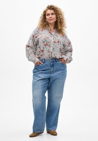 Striped, floral blouse with long sleeves, paired with high-waisted, light blue wide-leg jeans. Soft texture with natural tones and gentle patterns.