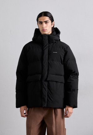 Black puffer jacket with a high collar and attached hood. Features quilted panels, a central zipper, and two large front pockets.