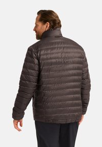 Dark gray puffer jacket with horizontal quilting, high collar, and elastic cuffs. Textured, synthetic material provides insulation.