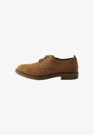 Brown suede lace-up shoe with a rounded toe, contrasting stitching, and a low heel. Flat sole with a slight texture.
