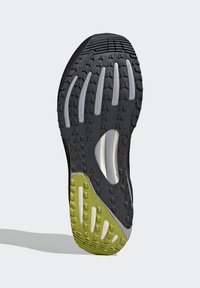 Black and green athletic shoe sole with deep treads and textured grip, featuring a "Continental" logo near the toe area.