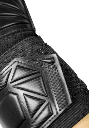 Close-up of a black Reusch sports glove showing textured protective padding and elastic wristband.