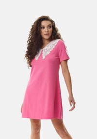 Short pink dress with short sleeves, featuring a lace detailed collar. Smooth fabric with a relaxed fit and knee-length design.