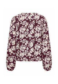 Blouse à manches longues avec fond bordeaux et imprimé floral blanc, avec une coupe décontractée et des poignets froncés.