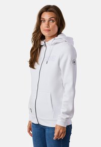 Weiße Zip-Hoodie mit Fronttaschen, Kapuze mit Kordelzug und gesticktem "Lakeside"-Text. Geschmeidiger Stoff und gerippte Bündchen.