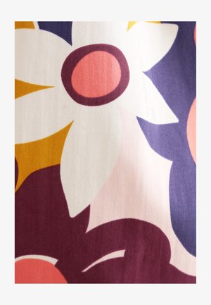 Floral fabric featuring large white and pink flowers with dark purple accents, set against a light-colored background with warm yellow details.