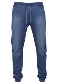 Pantalones jogger de denim con cintura elástica y cordón ajustable. Color azul oscuro, pierna ajustada, puños elásticos y detalles desgastados.