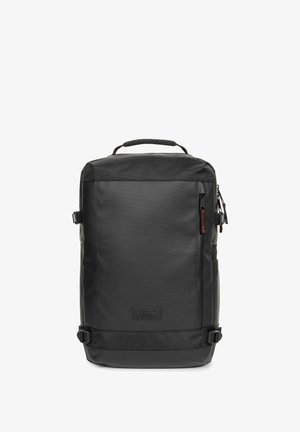 Black backpack with a smooth, water-resistant material, a top handle, side buckles, and a textured panel on top. Features a zip closure.