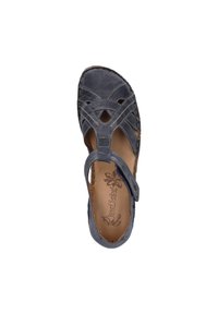Dark blue leather sandal with cross-strap design, cutouts, and adjustable Velcro closure. Soft interior lining and textured sole.