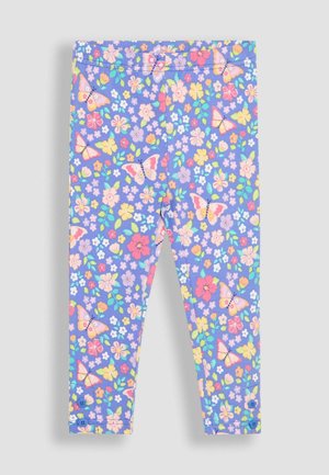 Leggings violets avec un motif floral et de papillons en rose, jaune et vert. Présentent une texture douce et une taille élastique.