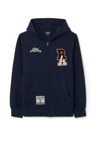 La sudadera azul marino presenta un cierre frontal con cremallera, dos bolsillos laterales y parches bordados con texto. Tejido suave con puños y dobladillo acanalados.