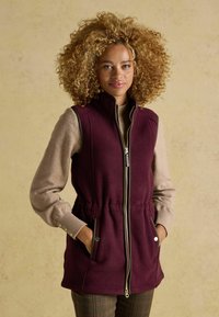 Bordeaux farbener ärmelloser Weste mit hohem Kragen und Kordelzug in der Taille, mit Reißverschluss,Seitentaschen und weichem Fleece-Material.