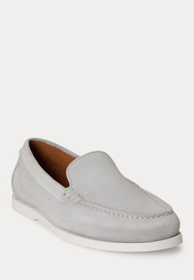 Light gray suede loafer with white sole, rounded toe, and detailed stitching along the top and sides, displayed against a plain background.