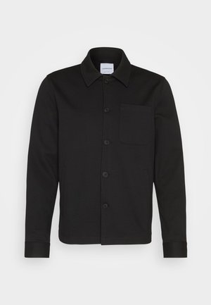 Black button-up jacket made of smooth fabric, featuring a collar, front pocket, and cuffed sleeves. No visible patterns or accents.