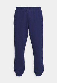 Mörkblå träningsbyxor i bomullsblandning. Elastisk midjereså med dragsko, sidofickor och avsmalnande muddar. Diskret märkeslogotyp.