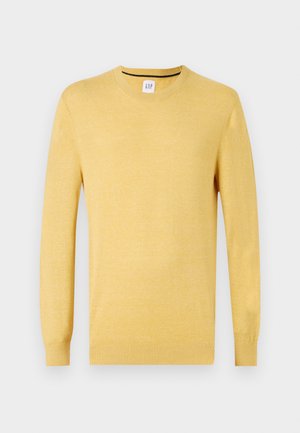 Pull jaune à manches longues avec un col rond. Fabriqué en tissu tricot doux, avec des poignets et un ourlet côtelés. Design simple et sans ornements.