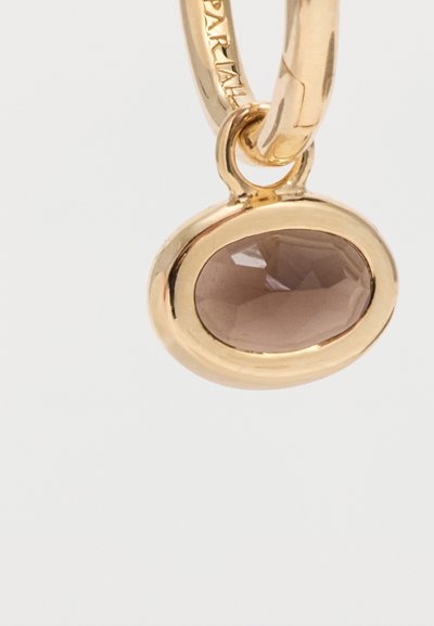 Χρυσό σκουλαρίκι κρίκος με ένα κρεμαστό οβάλ πολύεδρο καφέ πολύτιμο λίθο, τοποθετημένο σε χρυσό πλαίσιο, πάνω σε λευκό φόντο.