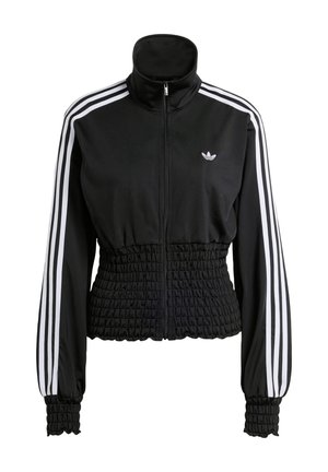 Schwarze Trainingsjacke mit hohem Kragen, durchgehendem Reißverschluss und elastischem Taillenbund mit Raffung. Verfügt über weiße Schulterstreifen und gerippte Bündchen. Adidas-Logo sichtbar.
