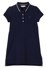 Granatowa sukienka polo z krótkimi rękawami, z placketem na dwa guziki i kontrastowymi białymi paskami na kołnierzyku. Posiada lekką tkaninę i boczne rozporki.
