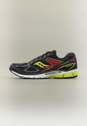 Black athletic shoe with red and yellow accents, mesh upper, white sole, and visible "GUIDE" and "progrid" branding on the side.