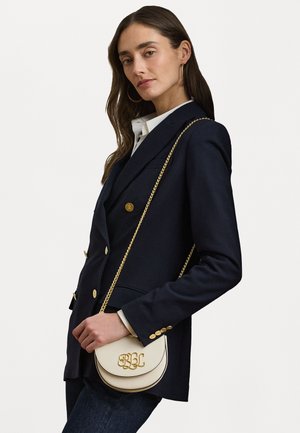 Borsa a tracolla in pelle color crema con forma curva, hardware dorato e iniziali impresse "BBL". La tracolla a catena aggiunge un tocco di dettaglio.