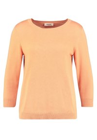 Pull en tricot orange clair à col rond et manches trois-quarts. Présente des accents côtelés au niveau des poignets et de l'ourlet. Design classique.