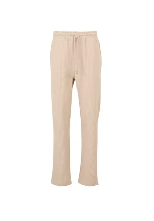 Pantalons côtelés beiges avec une taille élastique et un cordon de serrage, présentant une coupe décontractée et des jambes droites. Pas de poches visibles ni d'ornements.