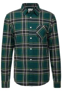 Vihreä ruudullinen nappipaita, jossa on valkoisia, mustia ja keltaisia yksityiskohtia; sisältää rintataskun ja klassisen kauluksen; valmistettu flanellikangasta.