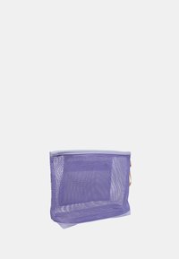 Borsa a rete viola con forma rettangolare, con bordo superiore solido e manici beige. Il design consente di vedere il contenuto all'interno.