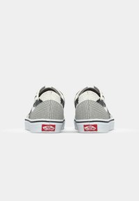 Vans sneakers with a gray mesh upper, white rubber sole, and red branding on the heel. Features a low-top, slip-on design.