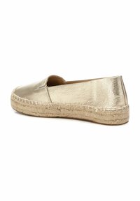 Espadrille metálico dorado con parte superior cerrada, suela de yute y superficie de textura suave. Diseño simple, perfil bajo y estilo fácil de poner.
