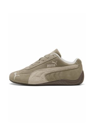 Suede sneakers in light brown with darker accents, featuring a low-profile design, lace-up closure, and branded logo on the side.