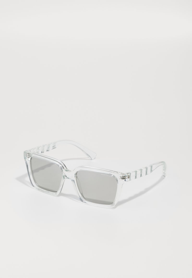 Clear plastic sunglasses with square gray lenses. The arms feature a striped pattern, and the frame has a chunky design with pronounced edges.