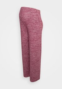 Vida byxdresser i vinröd melerad tyg, med en slät textur och en passform som är något avsmalnande i midjan.