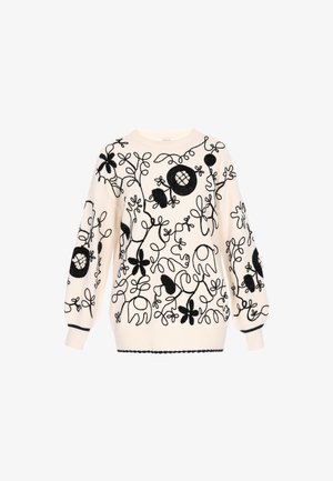 Suéter crema con bordado floral negro, mangas abullonadas y puños acanalados. Patrones intrincados con acentos texturizados en todo el diseño.