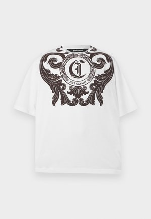 White short-sleeve t-shirt with large black ornate scroll design and circular logo featuring intertwined snake and "Just Cavalli" text across chest.