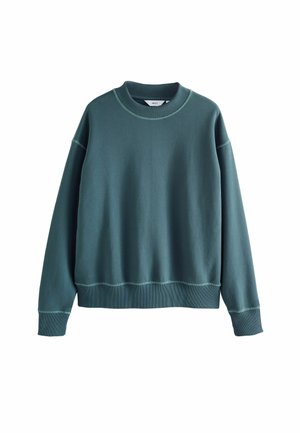 Sudadera color teal con cuello redondo, mangas largas y puños de canalé. Presenta costuras en contraste y un corte relajado. Textura de tela suave.