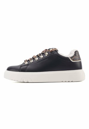 Black leather sneaker with white sole, metallic accents, and brown leopard print detail on the heel. Lace-up design with fur lining.