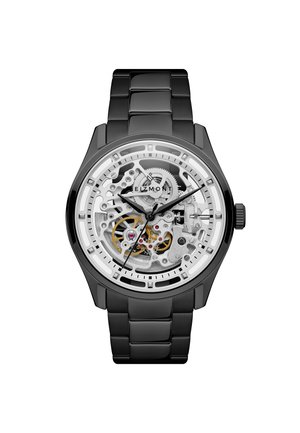 Musta metallirannekello, jossa on läpinäkyvä kellotaulu, joka paljastaa hopeiset ja kultaiset sisäiset hammaspyörät sekä mustat tunti-, minuutti- ja sekuntiviisarit.