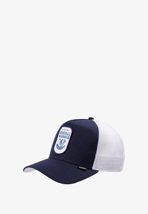 Gorra de camionero de malla en azul marino y blanco con visera curva y un parche que dice "Djinns Originales" con un diseño de ola y planta.