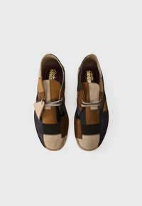 Men's shoes featuring a patchwork design in shades of brown, green, and navy with a suede finish, round toe, and beige lacing.