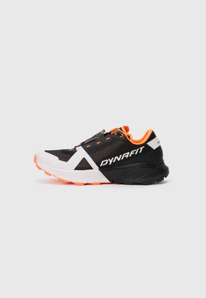 Black and orange DYNAFIT athletic shoe with white sole accents and secure fastening, designed for trail running or outdoor sports.