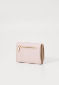 Pink leather wallet with a textured finish, featuring a gold zipper on the back and a fold-over design for compact storage.