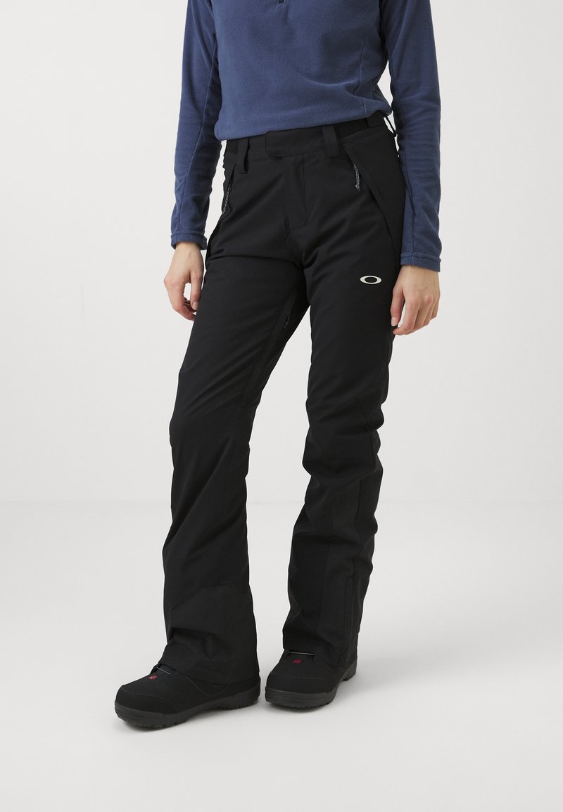 Sorte skibukser med et elegant design, der har lynlåslommer og et elastisk taljebånd. Fremstillet af et holdbart, vejrbestandigt stof.