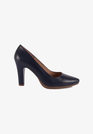 Zapato de tacón alto de cuero azul marino con punta afilada, textura suave y tacón sólido. El interior es de color marrón claro con un diseño curvado sutil.