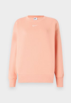 Rosa genser med ribbestrikket hals og mansjetter. Har en liten hvit Nike-logo på brystet. Mykt stoff med en avslappet passform.
