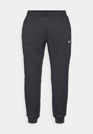 Schwarze Sporthosen mit einem elastischen Bund, schmal zulaufenden Beinen und einem kleinen weißen Nike-Logo auf dem linken Oberschenkel. Strukturiertete Stoff.