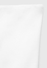 White cotton fabric with a soft, slightly textured surface, folded at the edge. No patterns or hardware visible.