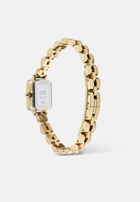 Gold stainless steel watch with a square face, link bracelet design, smooth texture, and a minimalist back displaying brand details.